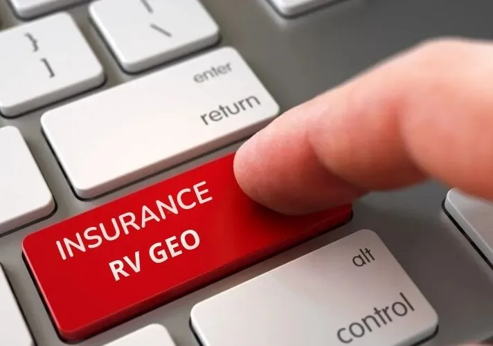  Close-up of a finger pressing a large red keyboard key labeled “INSURANCE RV GEO” on a computer keyboard.
