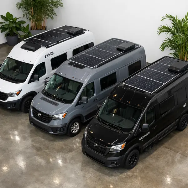 Three premium electric RV models Winnebago eRV2 Lightning ZEV Grounded G1 displayed in modern showroom for comparison
