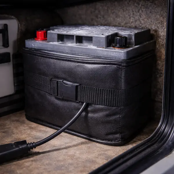battery warming blanket wrapped around agm battery in rv compartment with condensation visible on battery surface before warming in cold weather