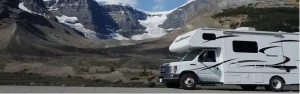 RV road trip in front of a mountain landscape