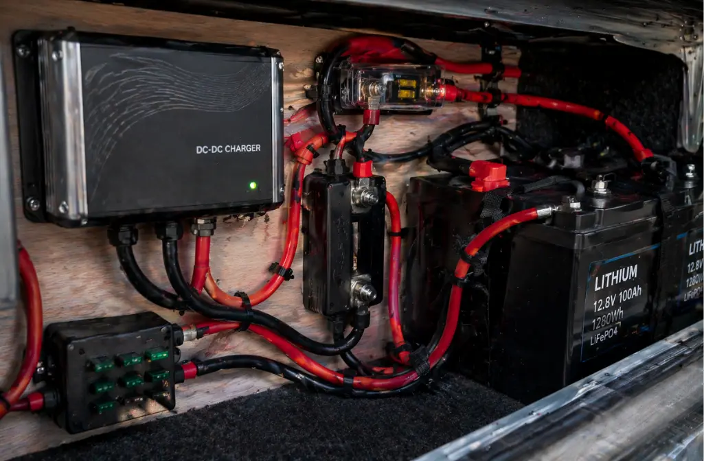 Organized RV electrical system with DC-DC charger, lithium batteries, fuse block, and clean wiring